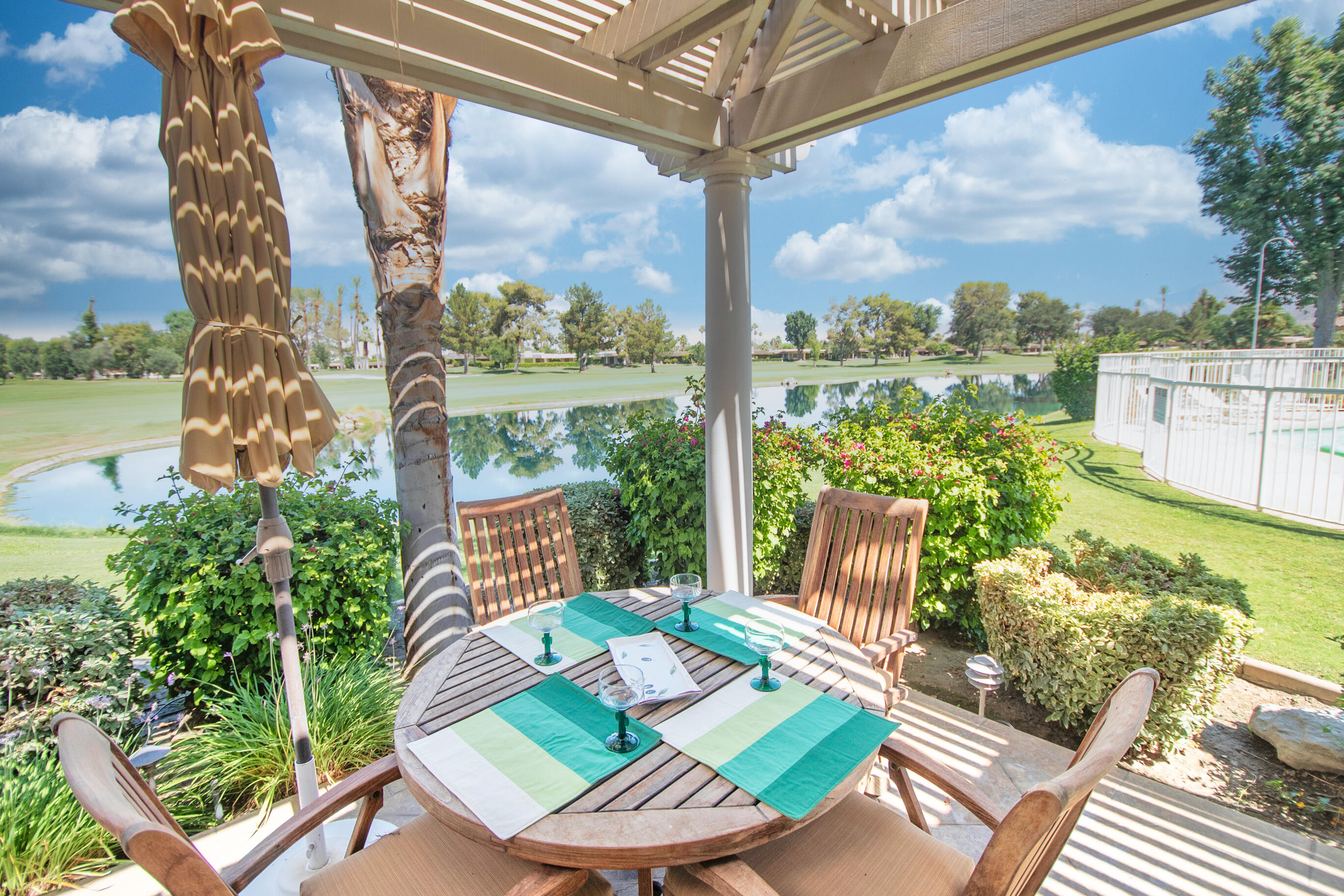 a view of a patio with a table chairs and a table