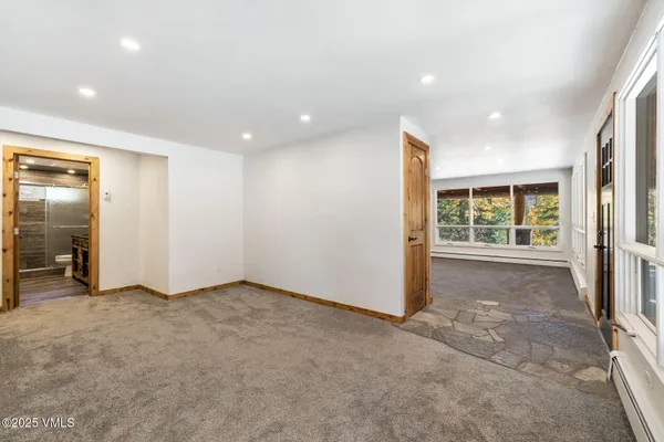 an empty room with windows and closet