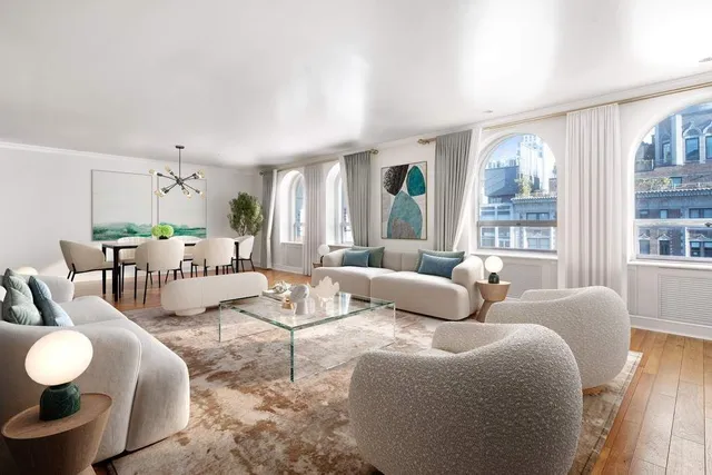 a bedroom with furniture and a large window