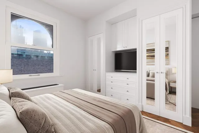 a living room with furniture chandelier and a large window