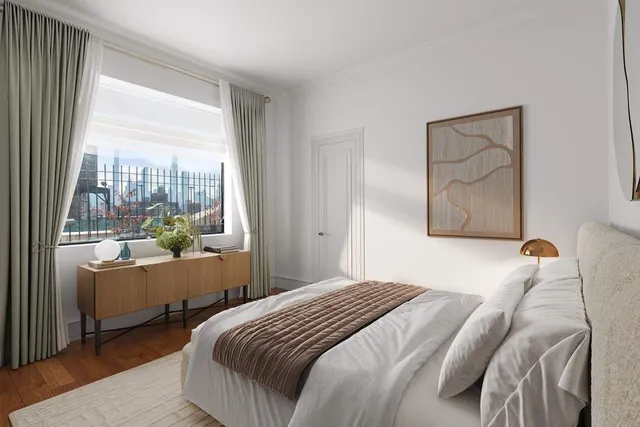 a bedroom with a flat screen tv and a bed