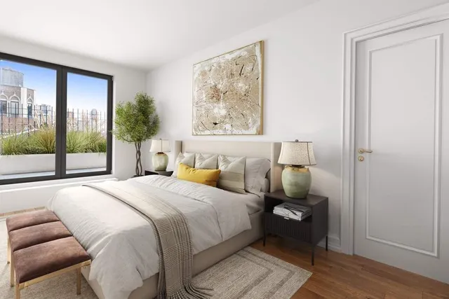 a bedroom with a bed and a large window