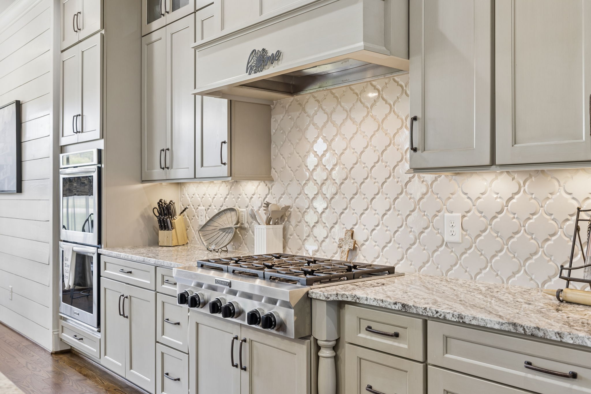 6033 Native Pony Trail College Grove, TN 37046 - Photo 35 of 87 a kitchen with granite countertop white cabinets and stainless steel appliances