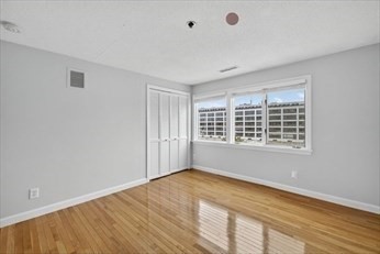 86 Wharf Street, Unit L6 Salem, MA 01970 - Photo 12 of 30 a view of an empty room with wooden floor and a window