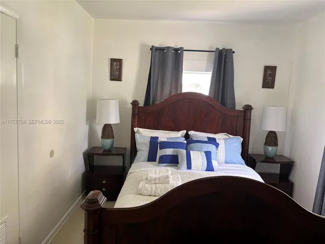 a bedroom with a bed and a mirror