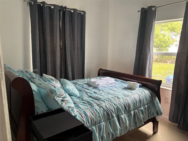 a bed sitting in a bedroom next to a window