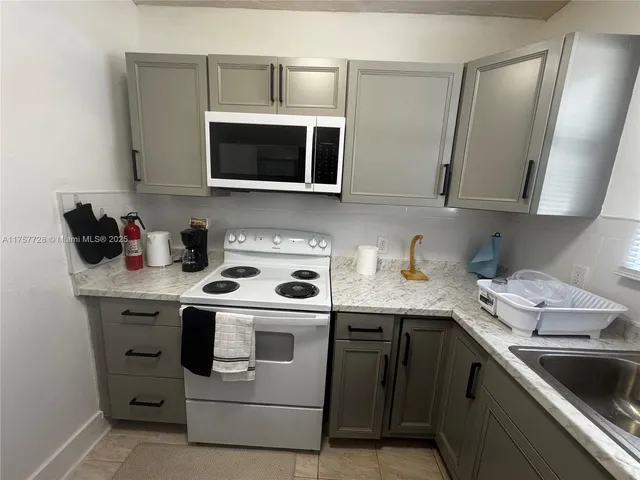 a kitchen with a sink stove and microwave