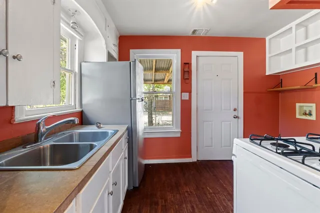 a kitchen that has a sink and a stove