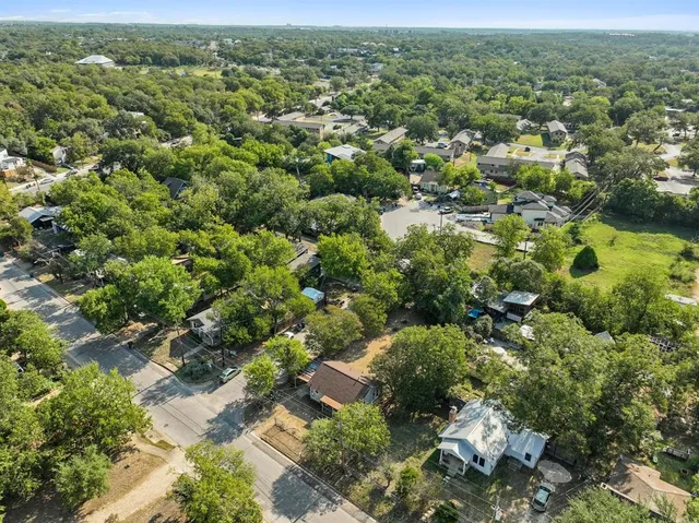 an aerial view of a houses with a yard