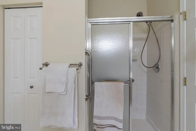 a bathroom with a glass shower door