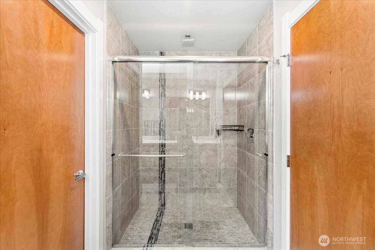 12418 2nd Place Southwest Burien, WA 98146 - Photo 16 of 39 a bathroom with a glass shower door