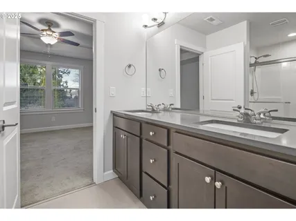 a bathroom with a sink double vanity and a mirror