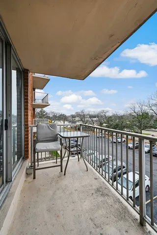 a view of a chairs and table in the balcony