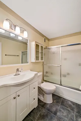 a bathroom with a toilet sink and a mirror