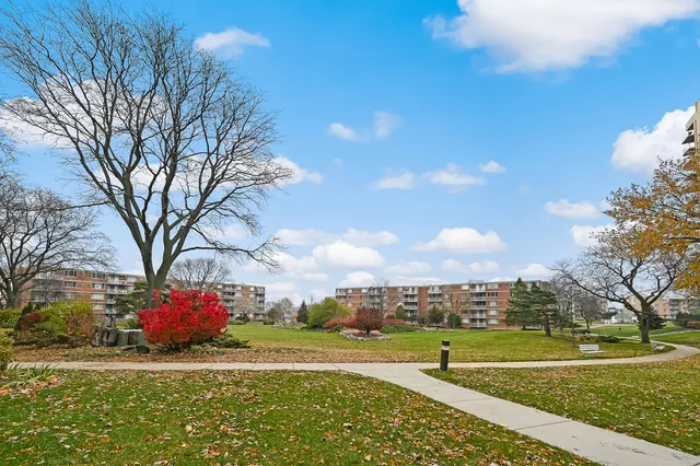 a view of a street with a building and a big yard