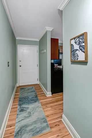 a view of a hallway view with wooden floor and staircase