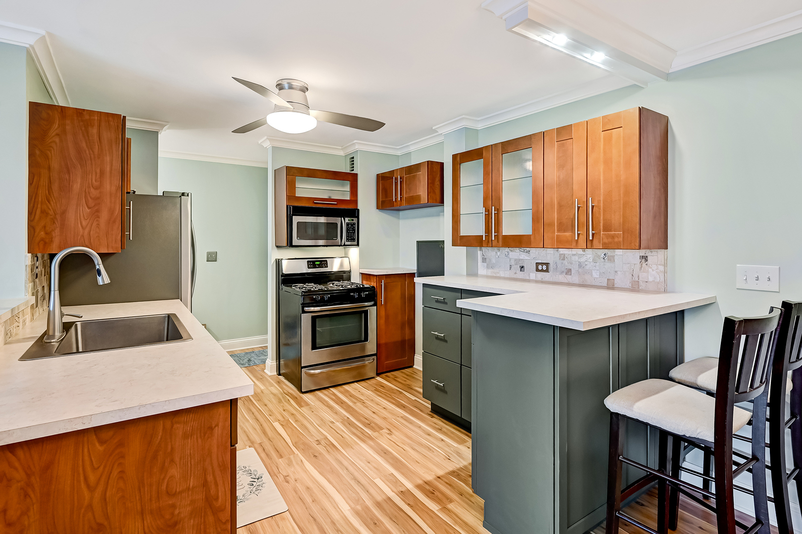2211 South Highland Avenue, Unit 3E Lombard, IL 60148 - Photo 7 of 25 a kitchen with a stove a sink and a refrigerator