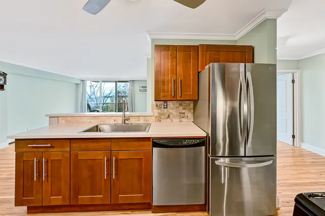 a kitchen with stainless steel appliances granite countertop a refrigerator and a sink