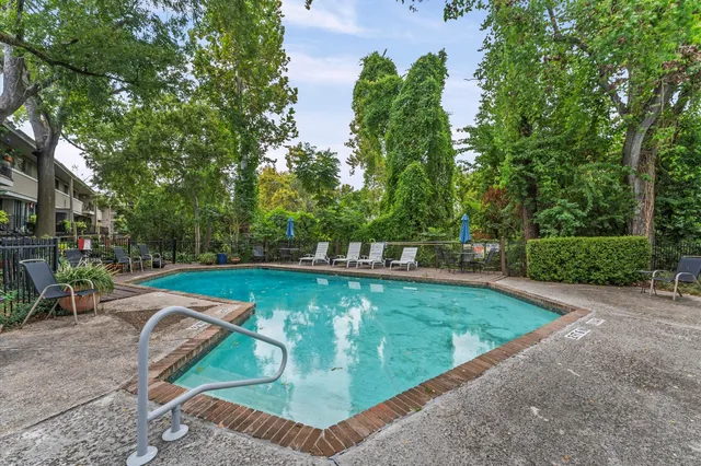 a view of a backyard with sitting area
