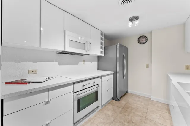 a kitchen with cabinets and steel stainless steel appliances