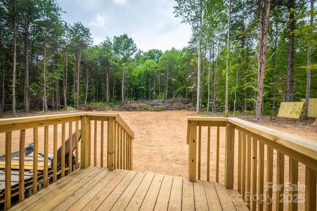 a view of balcony with wooden floor and fence
