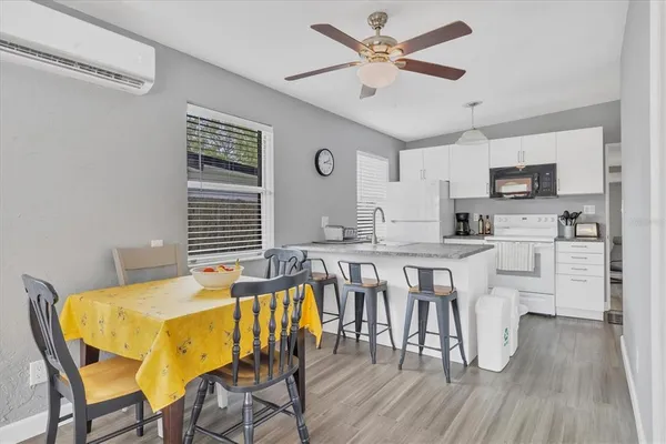 a view of a dining room with furniture and wooden floor