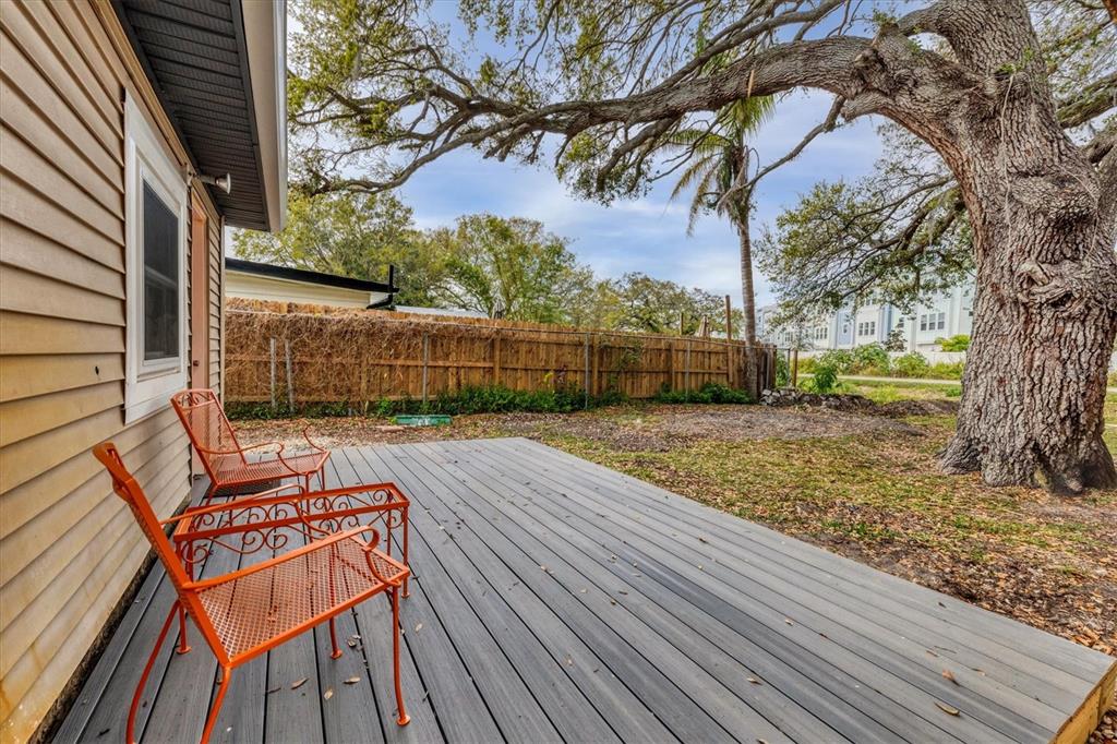 2305 Novus Street Sarasota, FL 34237 - Photo 21 of 28 a view of backyard with wooden fence and large trees