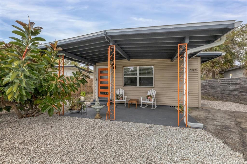 2305 Novus Street Sarasota, FL 34237 - Photo 3 of 28 a view of a backyard with a chair and potted plants