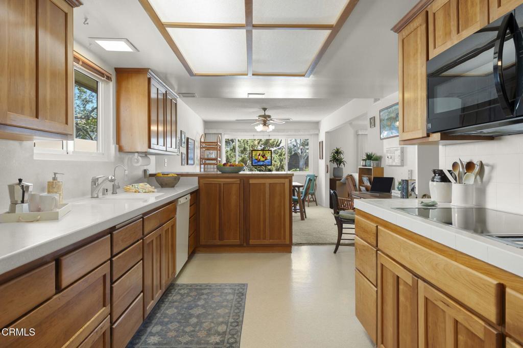 4907 Island View Street Oxnard, CA 93035 - Photo 20 of 44 a kitchen with stainless steel appliances granite countertop a sink a stove cabinets counter space and a window