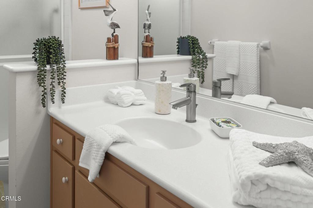 4907 Island View Street Oxnard, CA 93035 - Photo 32 of 44 a bathroom with a sink and a mirror