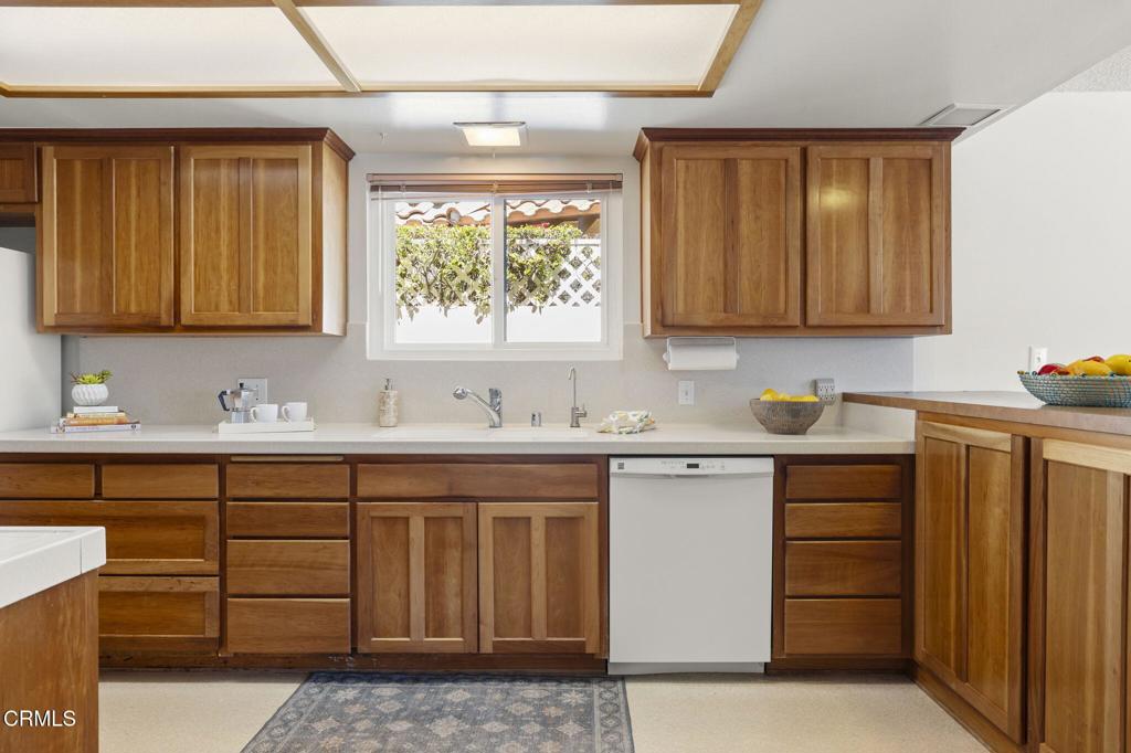 4907 Island View Street Oxnard, CA 93035 - Photo 6 of 44 a sink with granite countertop cabinets