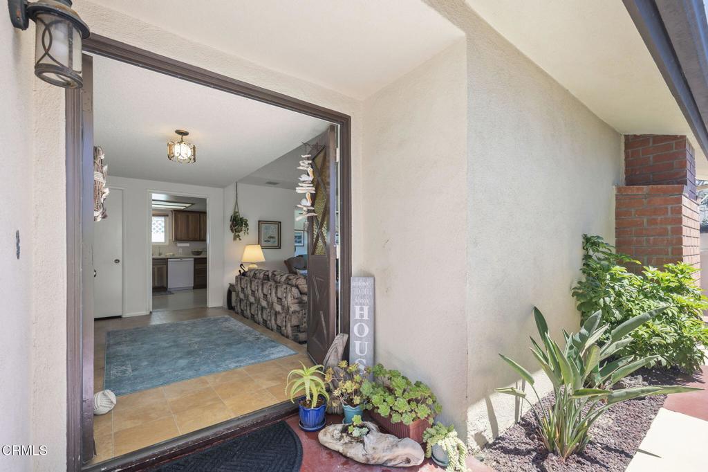 4907 Island View Street Oxnard, CA 93035 - Photo 9 of 44 a living room with furniture and a potted plant