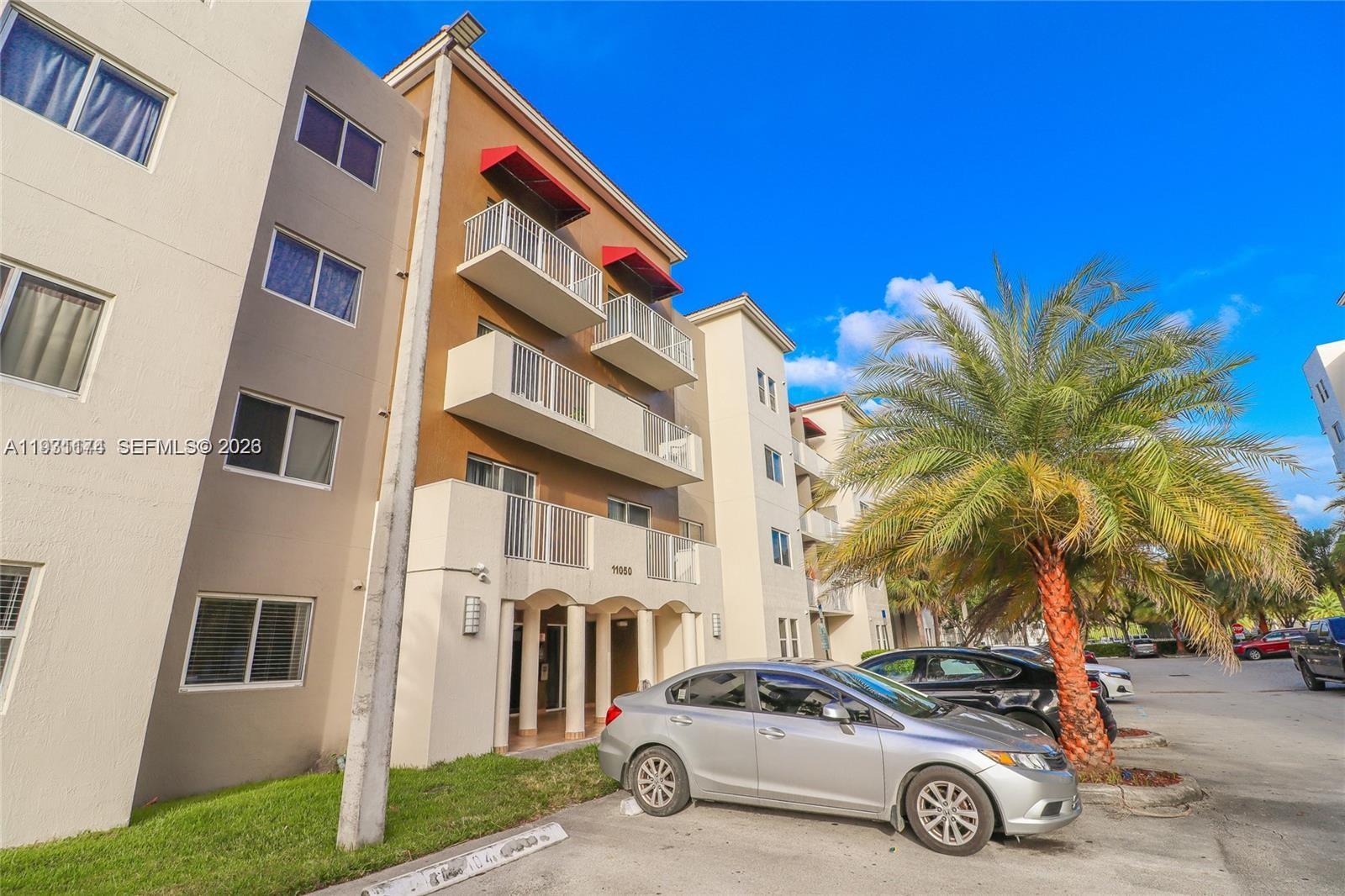 11050 Southwest 196th Street, Unit 305 Cutler Bay, FL 33157 - Photo 2 of 21 a car parked in front of a house