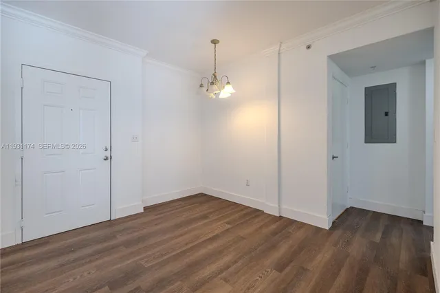 a view of a room with wooden floor and a ceiling fan