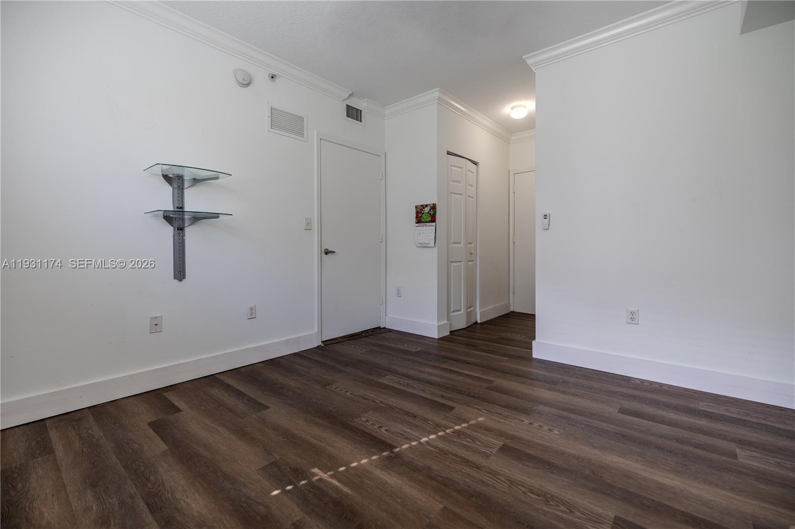 11050 Southwest 196th Street, Unit 305 Cutler Bay, FL 33157 - Photo 8 of 22 a view of an empty room with wooden floor and a window