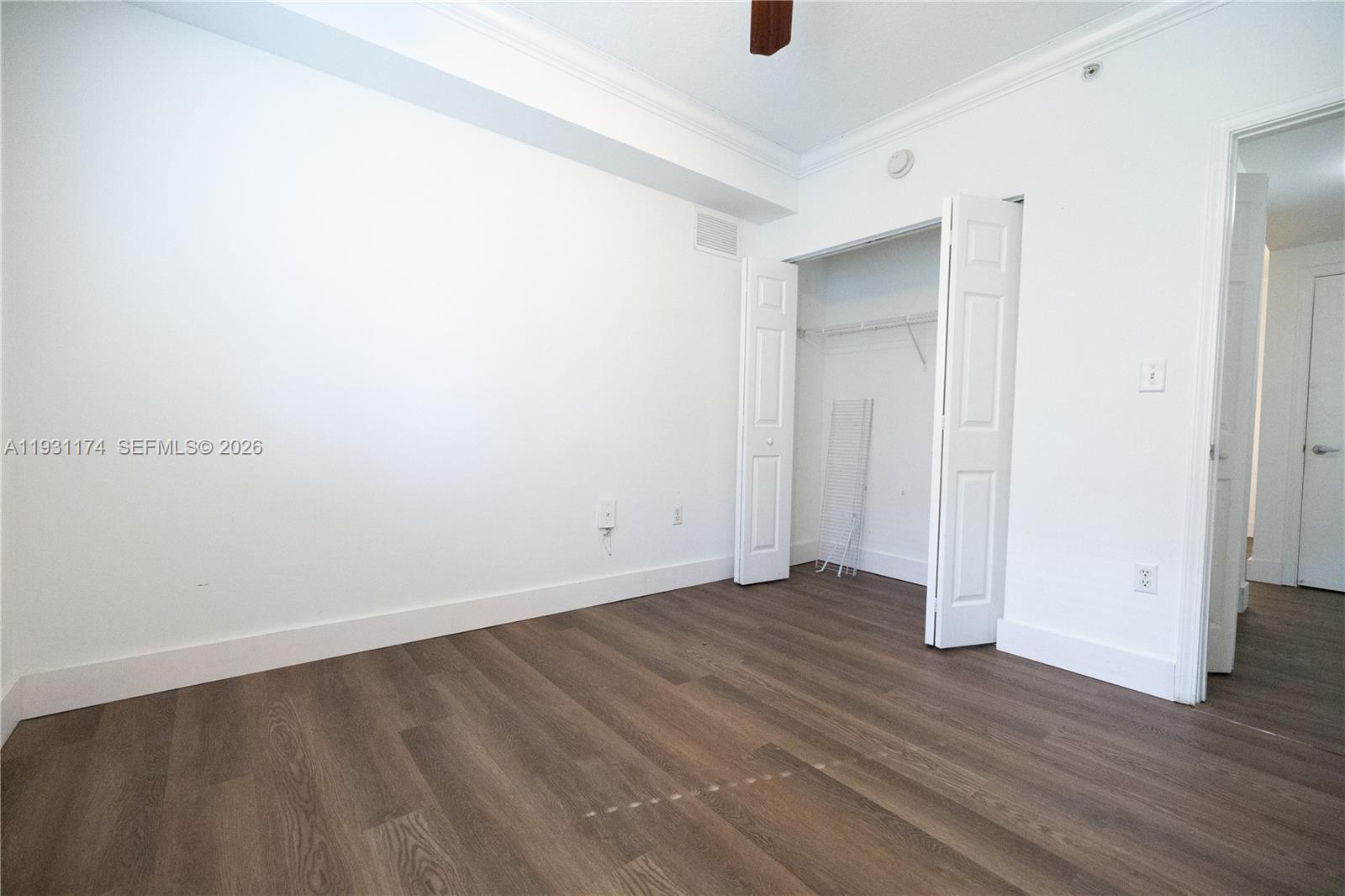 11050 Southwest 196th Street, Unit 305 Cutler Bay, FL 33157 - Photo 9 of 22 a view of an empty room with wooden floor