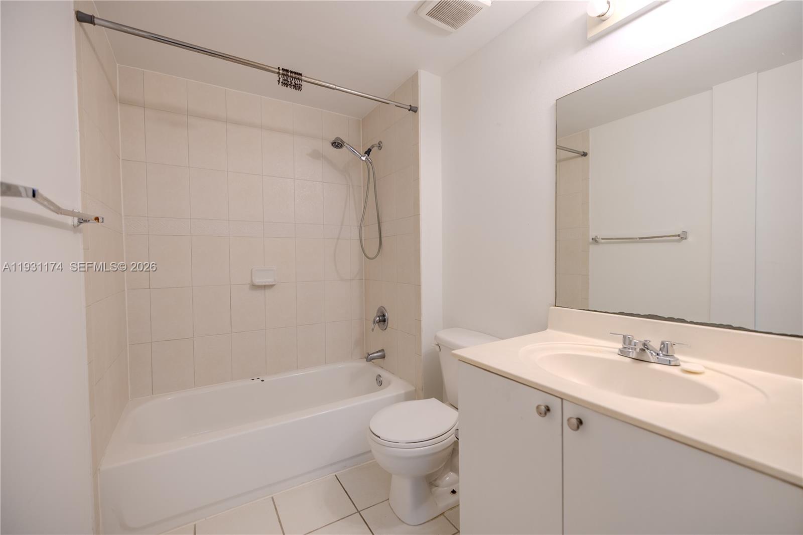 11050 Southwest 196th Street, Unit 305 Cutler Bay, FL 33157 - Photo 10 of 22 a bathroom with a sink a toilet and shower