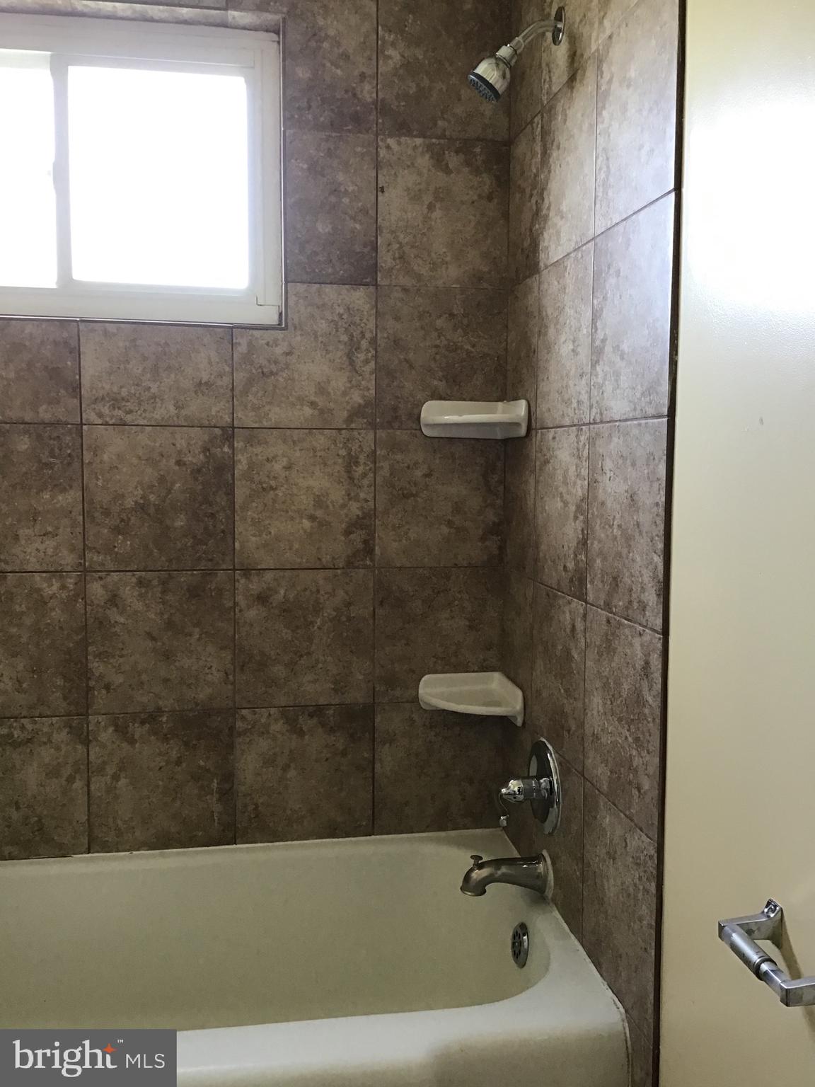 3867 26th Avenue Temple Hills, MD 20748 - Photo 17 of 27 a bathroom with a bathtub