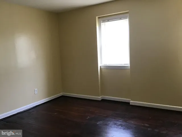 an empty room with wooden floor