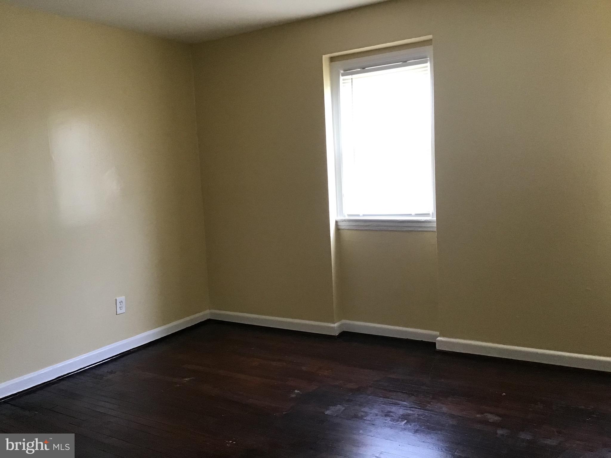 3867 26th Avenue Temple Hills, MD 20748 - Photo 20 of 27 an empty room with wooden floor and windows