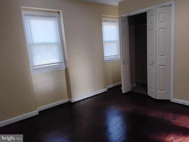 a view of an empty room and wooden floor