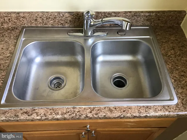 a kitchen with granite countertop cabinets sink and window