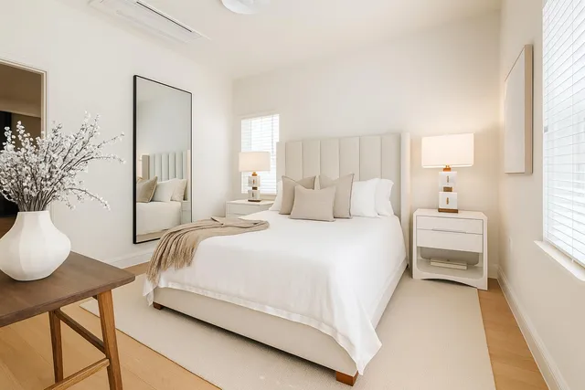 a bedroom with a bed and wooden floor