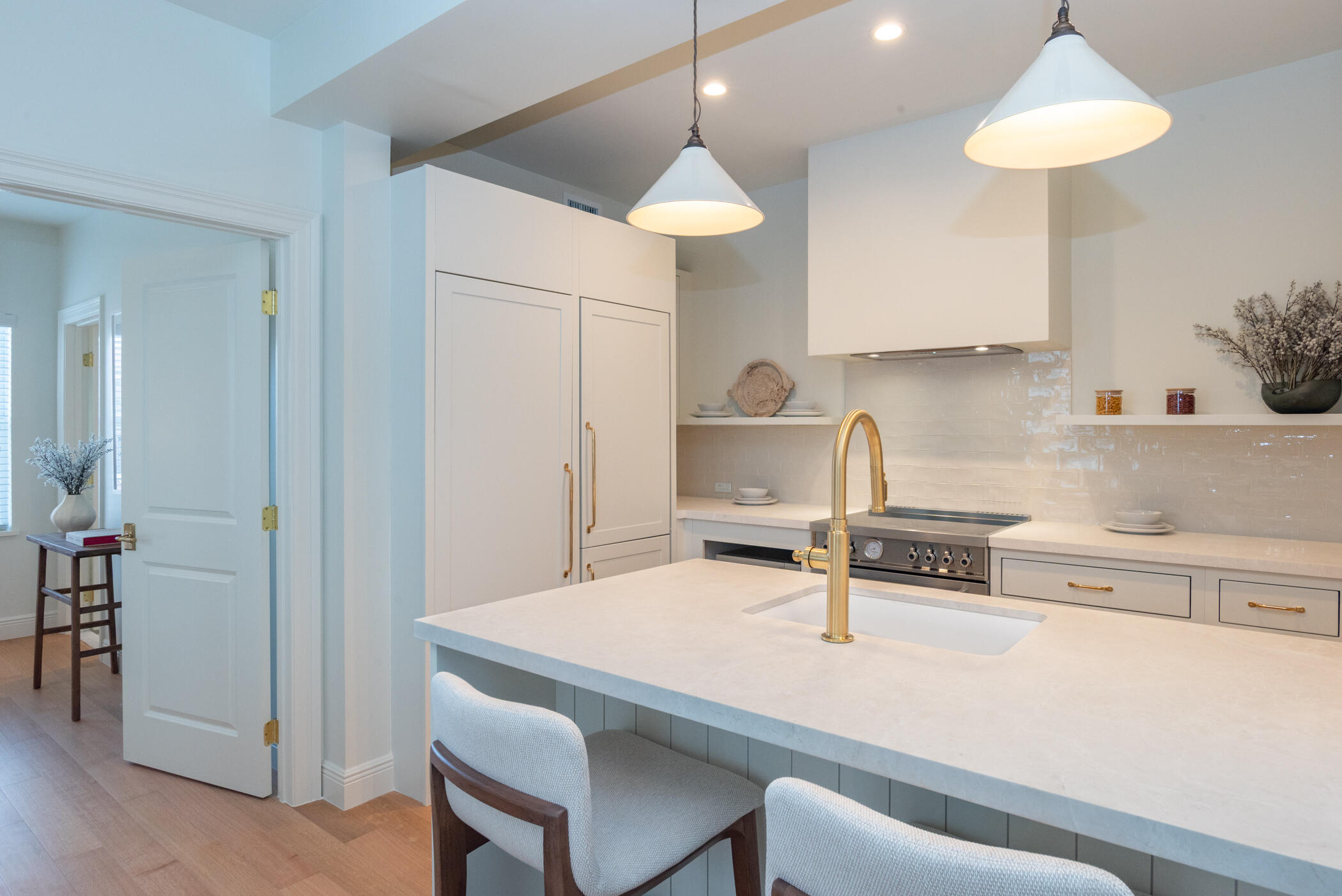 184 Sunset Avenue, Unit 303 Palm Beach, FL 33480 - Photo 4 of 11 a kitchen with a table a stove cabinets and wooden floor