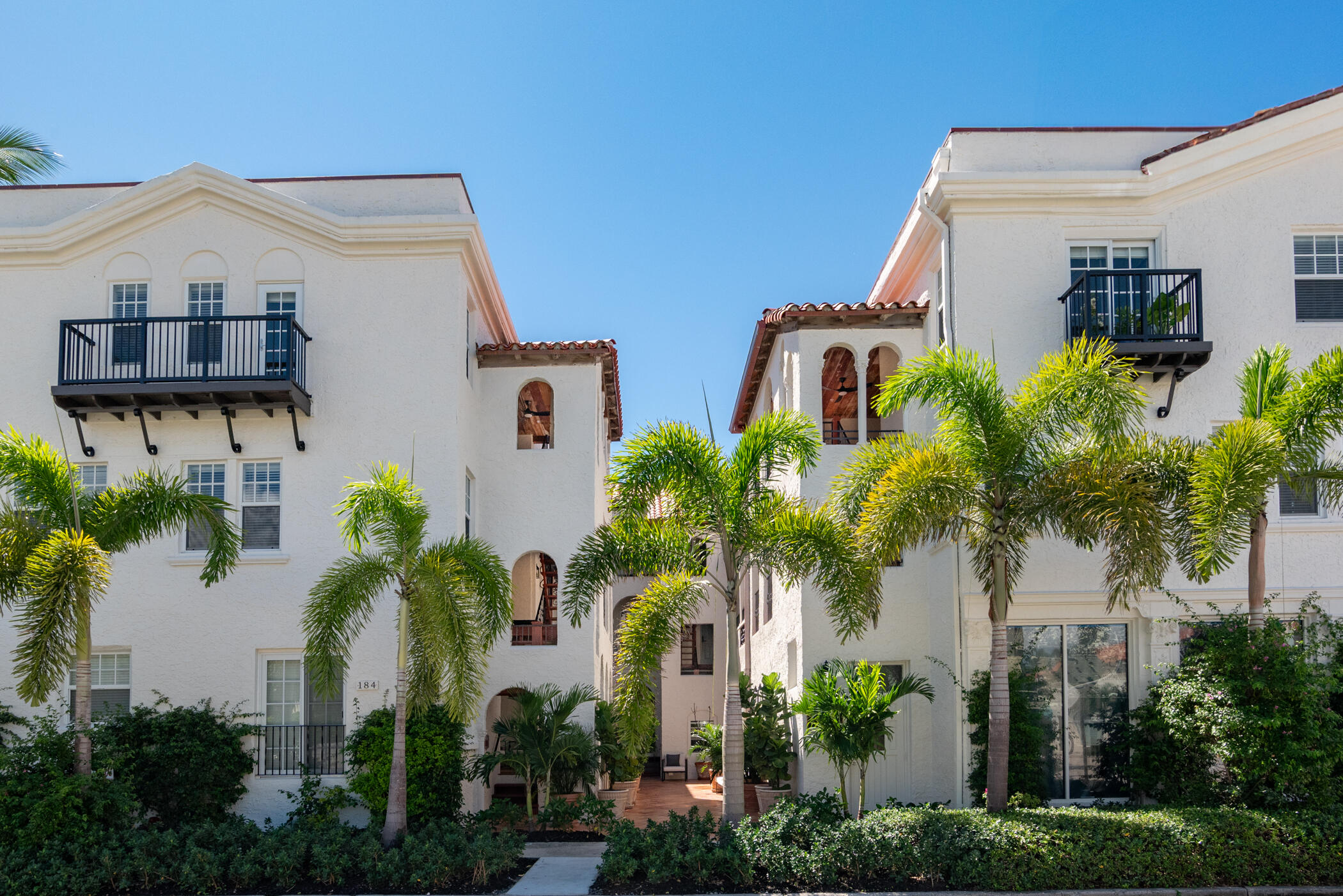 184 Sunset Avenue, Unit 303 Palm Beach, FL 33480 - Photo 8 of 11 a front view of a house with plants and entryway