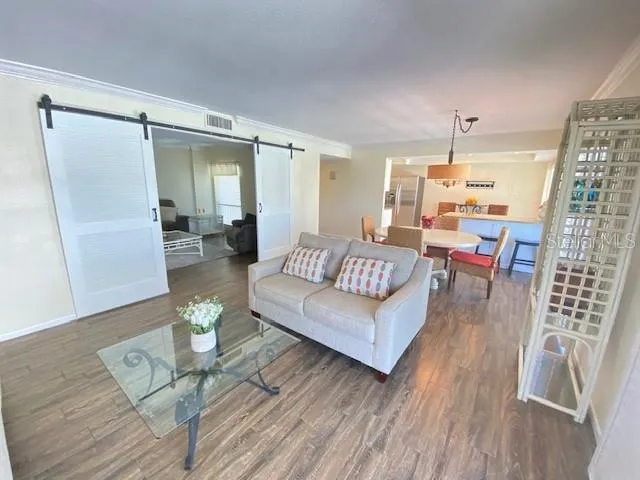 a living room with furniture and wooden floor