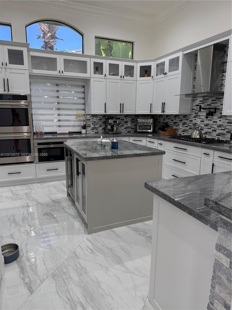 18610 Southwest 39th Court Miramar, FL 33029 - Photo 12 of 32 a kitchen with stainless steel appliances granite countertop a sink stove and cabinets