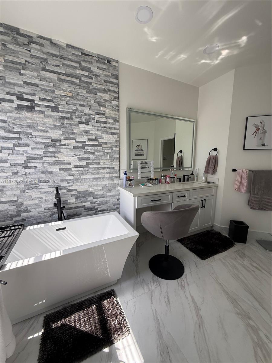 18610 Southwest 39th Court Miramar, FL 33029 - Photo 16 of 32 a bathroom with a sink a toilet and mirror