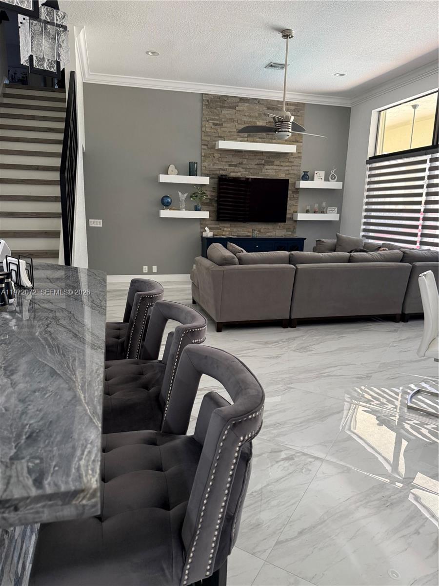 18610 Southwest 39th Court Miramar, FL 33029 - Photo 19 of 32 a living room with furniture a flat screen tv and a fireplace