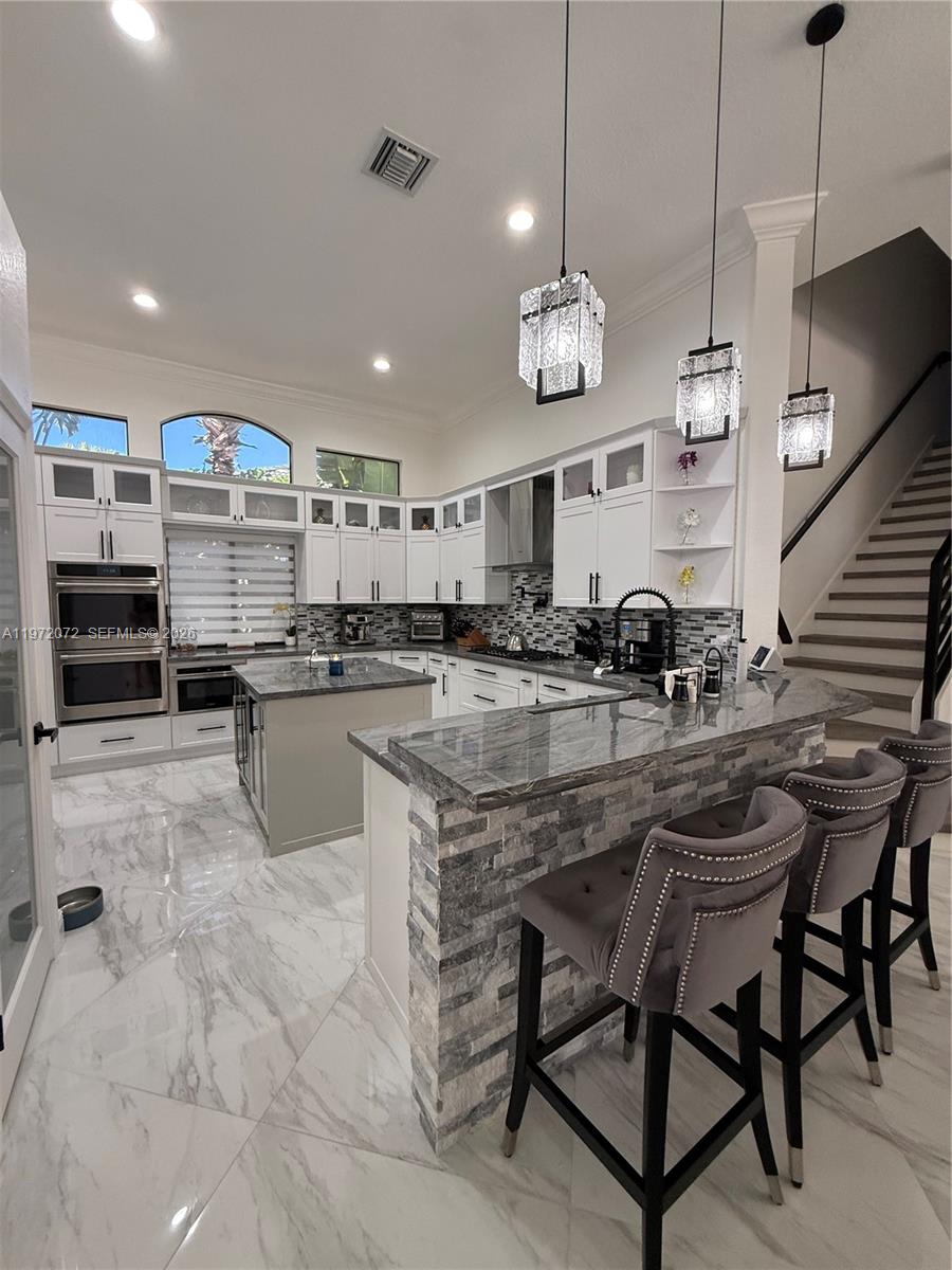 18610 Southwest 39th Court Miramar, FL 33029 - Photo 2 of 32 a large kitchen with a table and chairs in it